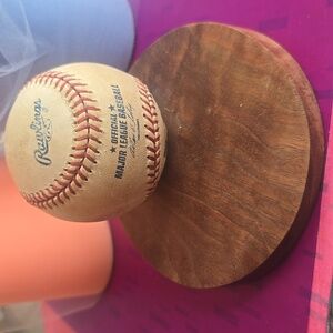Rawlings Baseball with Red Stitching on Wooden Base